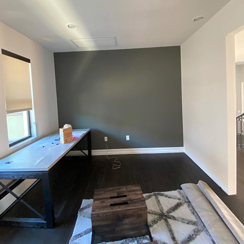 Home office with a freshly painted dark accent wall